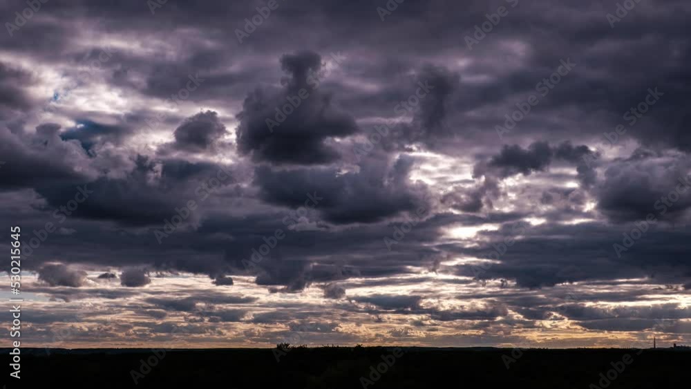 Wall mural timelapse of dramatic storm clouds moving in the sky over horizon. dark stormy cumulus clouds change