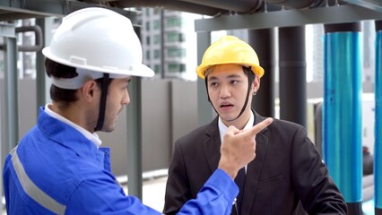 Professional Asian foreman and construction manager talking - discussing together.