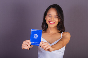 young adult woman from northeastern brazil. holding work card and social security. human Resources.