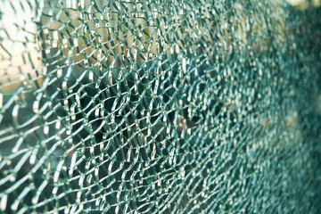 Cracked triplex glass window background. Closeup abstract backdrop