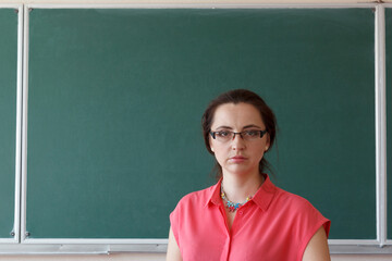 Woman in front of chalkboard