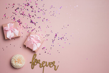 Pink gift box with a word forever over the pink background. 