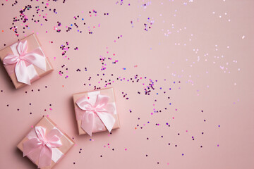 Pink gift boxes over the glitter background with copy space.