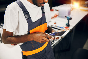 African factory worker using tablet