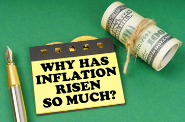 On a green surface are a pen, dollars and yellow stickers with the inscription - Why has inflation...