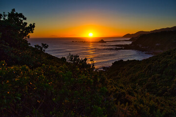 Sunset over Houghton Bay, Wellington, with views to the South Island, New Zealand