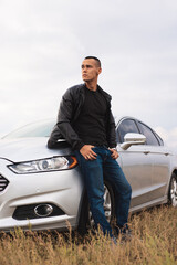 Handsome stylish man standing near his car at the field - 530221870