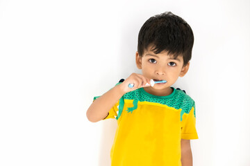 Cute little Kid brushing his teeth smiling very happy and enjoying isolated on white background. Dental Hygiene of little kid medical care. Oral Health awareness for kids and infant concept...