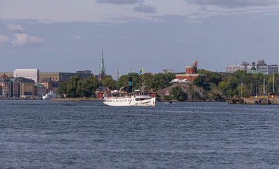 Fototapeta na wymiar Old steam boat leaving for the archipelago, a sunny autumn day in Stockholm