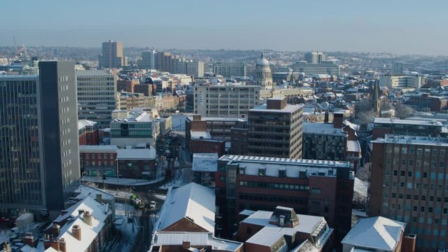 Cinematic aerial of Nottingham city hall covered in snow during winter