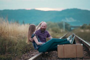 Fototapeta premium Young happy couple on the tram railways