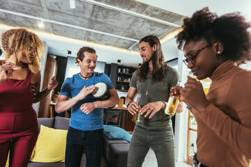 Friends dance fun at a student's party in the apartment