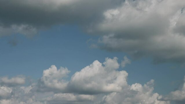 Timelapse of cumulus clouds moving in the blue sky. Light clouds change their shape in cloud space. 
