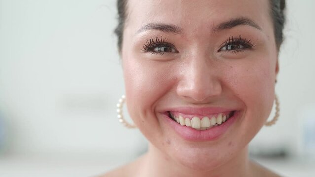 Front close up of asian woman, beautiful young human face, look at camera open and confident. Smiling elegant young girl