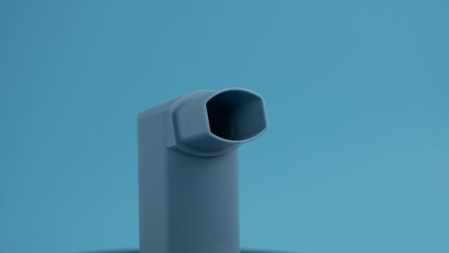 Asthma medicine. Inhaler for asthma on a blue background.