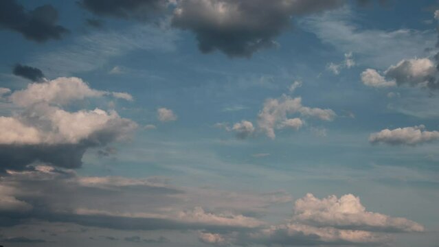 Timelapse of cumulus clouds moving in the blue sky. Light clouds change their shape in cloud space. 