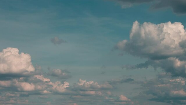 Timelapse of cumulus clouds moving in the blue sky. Light clouds change their shape in cloud space. 