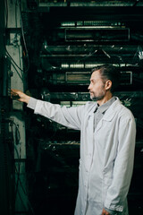 Engineer working with machines at polymer factory