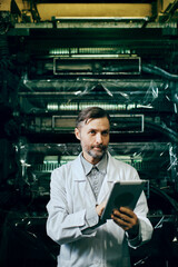 Engineer with tablet working at polymer factory