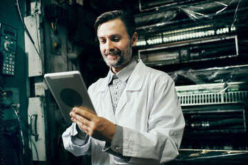 Engineer with tablet working at polymer factory