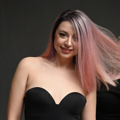 Beautiful woman with long straight color hair. Fashion model posing at studio.
