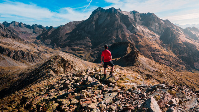 Photograph of a boy admiring the immensity of the mountains in the Panticosa Valley, a day of trekking next to the Vignemale peak, in the Pyrenees, Spain.
