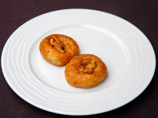 Turkish Dessert Sekerpare on white plate. Small cakes with Almond and Sherbet Syrup, top view