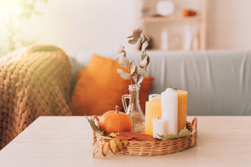 Autumn interior with candles and pumpkin.