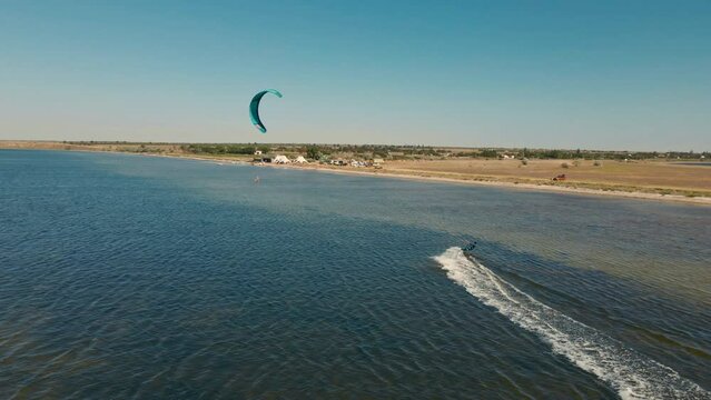 aerial view slow motion active man kiteboarding and windsurfing at beautiful sunset, active lifestyle extreme sport concept. Ukraine, Mikolaiv region