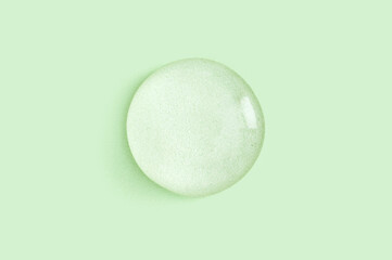 drop of serum gel cosmetic essence on a light pastel background