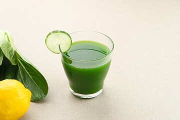 A glass of Green Juice, made from organic pakcoy, cucumber and lemon, very good for health. Cold Pressed Juice
