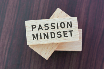 Passion mindset word on wooden block with wooden background.