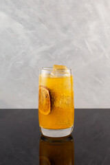 Yuzu and Passion fruit drink cocktail. Fruit lemonade based Orange juice. Refreshing sparkling Iced...