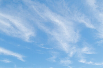 White fluffy clouds in the blue sky. Blue sky background and white clouds soft focus, pastel sky