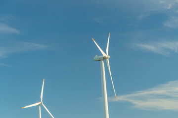 Fototapeta premium Green energy on wind turbines and wind turbines. Alternative energy sources and renewable energy sources. Power generation and generators of power plants.Wind farm and wind,environmental conservation