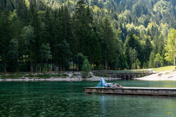 Woman enjoying the mountains view at lakeside in Slovenia 