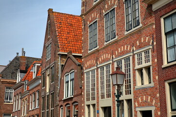 The colorful facades of historic houses located along Korenmarkt street near the harbor (Binnenhaven) of Hoorn, West Friesland, Netherlands