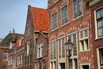Foto op Plexiglas The colorful facades of historic houses located along Korenmarkt street near the harbor (Binnenhaven) of Hoorn, West Friesland, Netherlands © Christophe Cappelli