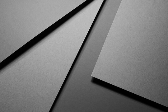 Graphite grey abstract geometric background with soar rectangle spaces, stripes, lines, corners in hard light, black shadows - simple strict modern style for business card, poster, flyer, top view.