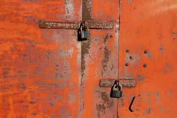 The lock on the rusty metal gate on the garage