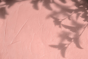 Shadow of eaves on pink concrete wall texture with roughness and irregularities. Abstract trendy colored nature concept background. Copy space for text overlay, poster mockup flat lay 
