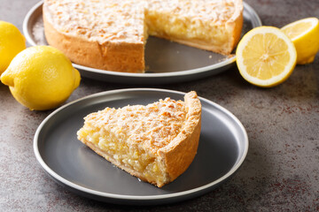 Homemade grated cake tart with lemon curd close-up in a plate on the table. Horizontal