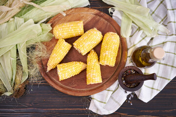 Organic natural corn cobs on wooden kitchen table