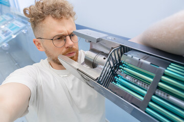 Man student engineer background fragment energy fuel uranium or thorium rod element of nuclear...