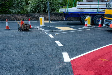 Road workers applying hot melt traffic resistant paint for white, yellow and red road marking lines...