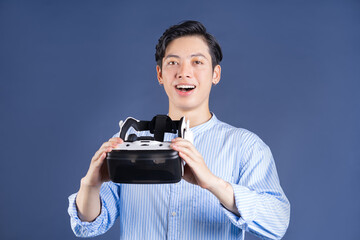 Fototapeta premium Young Asian man using VR glassses on backgroud