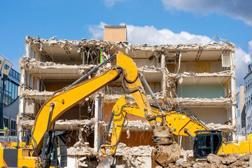 Demolition of building. Excavator breaks old house. Making space for the construction of a new houses