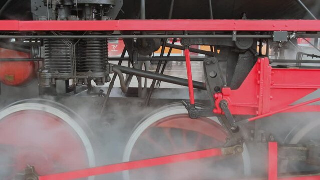 Tracking shot of wheels of the old style steam train locomotive