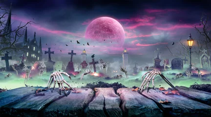 Fototapeten Halloween - Zombie Rising On Wooden Table - Skeletons Party In Graveyard At Spooky Nights With Blood Moon © Romolo Tavani