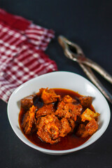 selective focus of delicious Indian style mutton curry with a decorative background. 